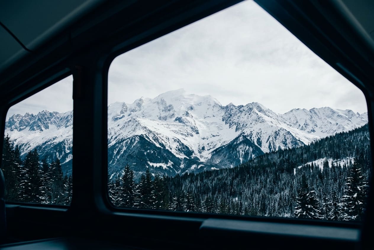 Snow-covered mountains through a train window